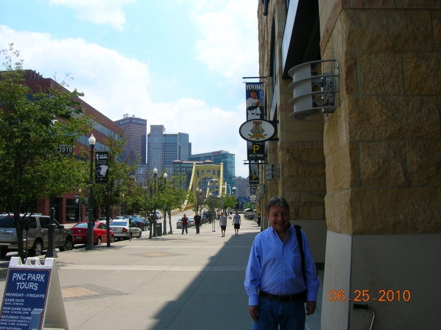 Brian outside PNC Park. Roberto Clemente bridge and city in background